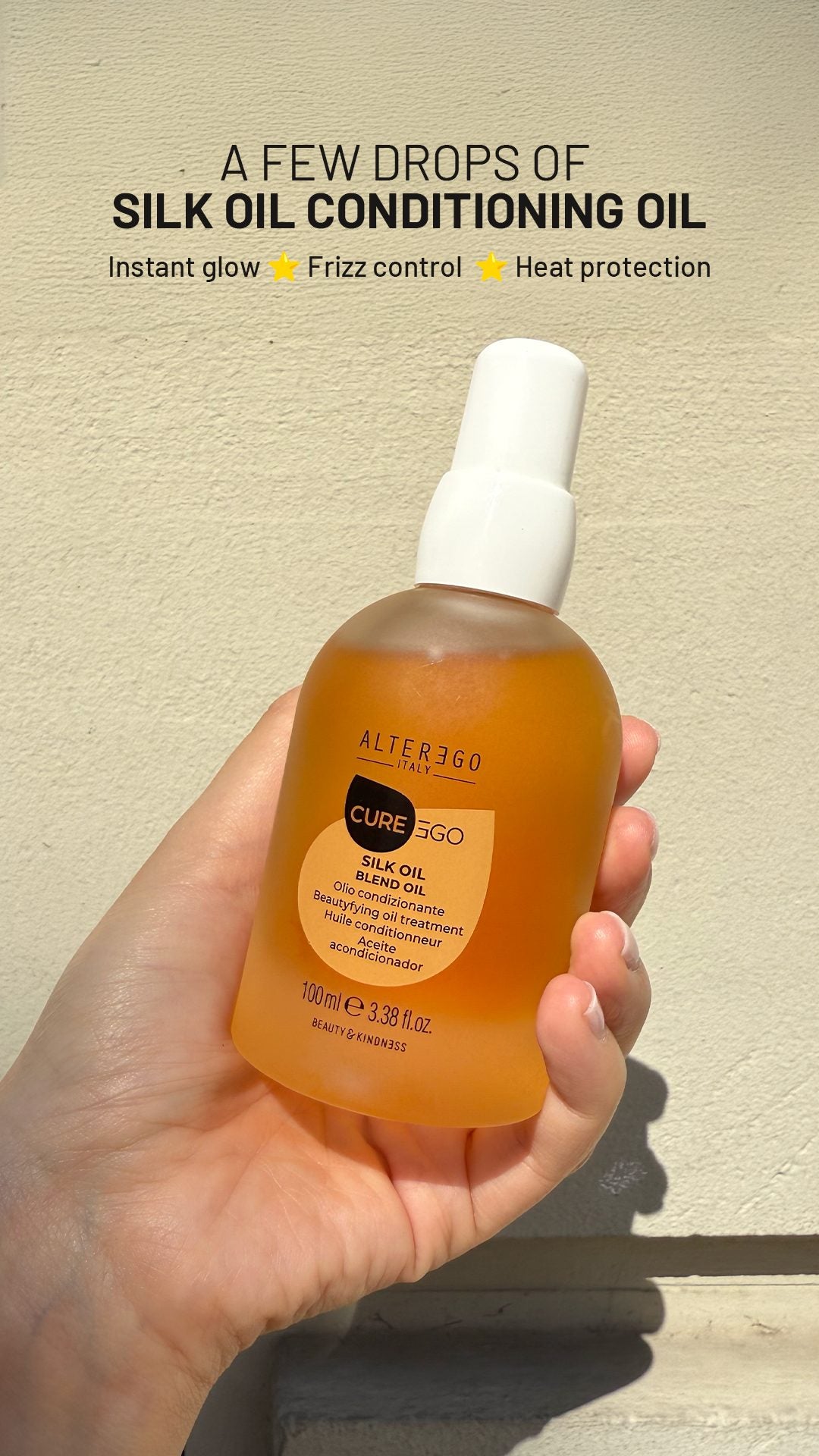 CurEgo Silk Oil Blend Oil 100ml held in hand — instant glow frizz control heat protection