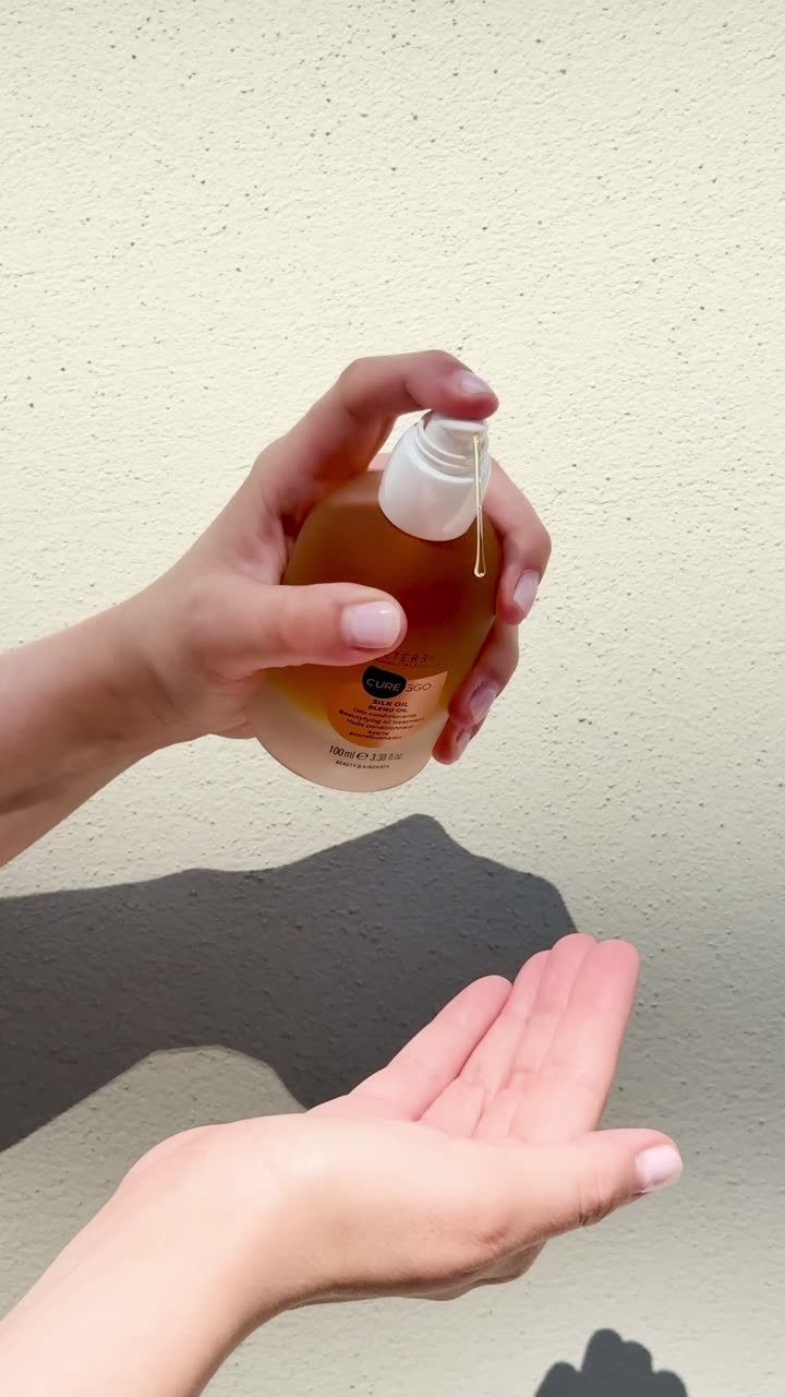 CurEgo Silk Oil Blend Oil being dispensed into palm — application demonstration